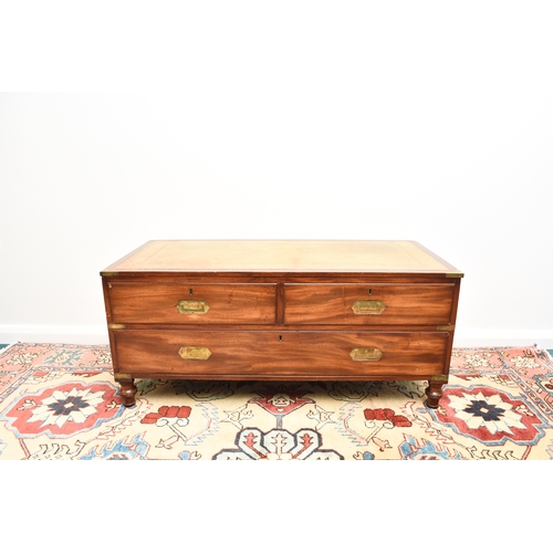 204 - A reproduction campaign type coffee table chest The brass-mounted top inset with a tooled green leat... 