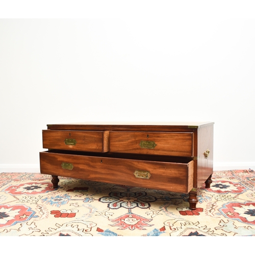 204 - A reproduction campaign type coffee table chest The brass-mounted top inset with a tooled green leat... 