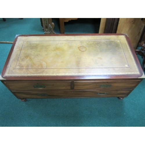 204 - A reproduction campaign type coffee table chest The brass-mounted top inset with a tooled green leat... 