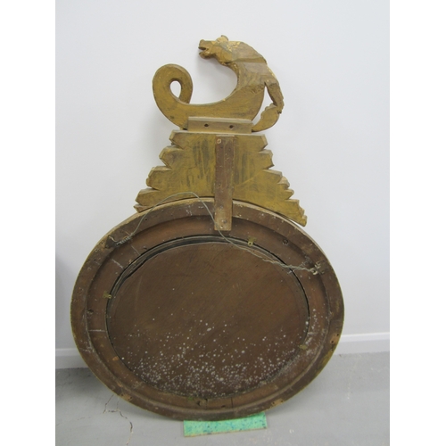 210 - A Regency giltwood and parcel ebonised convex mirror Circa 1820, the circular frame surmounted by a ... 