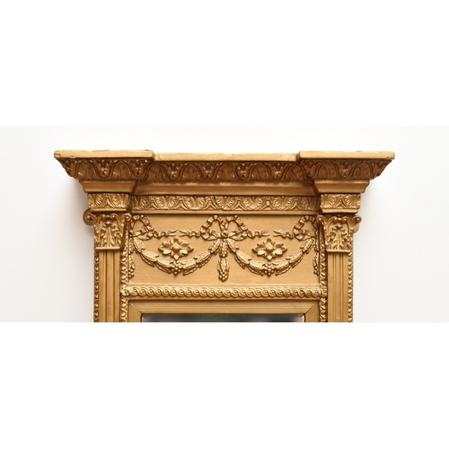 214 - A Regency Revival giltwood pier type wall mirror The bevelled rectangular plate within a frame with ... 