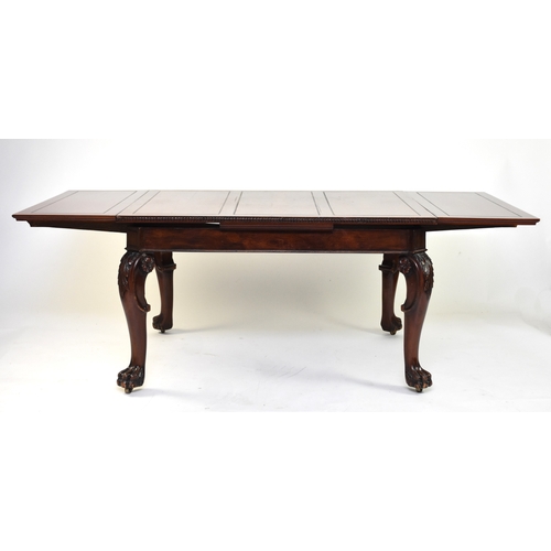 202 - A mahogany draw-leaf dining table, early 20th century The top with guilloche moulded edge above a pl... 