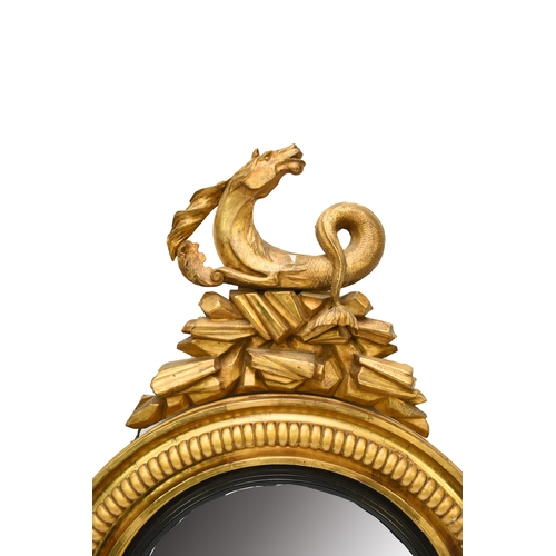 212 - A Regency giltwood and parcel ebonised convex mirror Circa 1820, the circular frame surmounted by a ... 