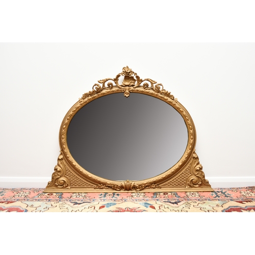 213 - A Victorian giltwood overmantel mirror The oval plate within a moulded frame with shell cresting. 13... 