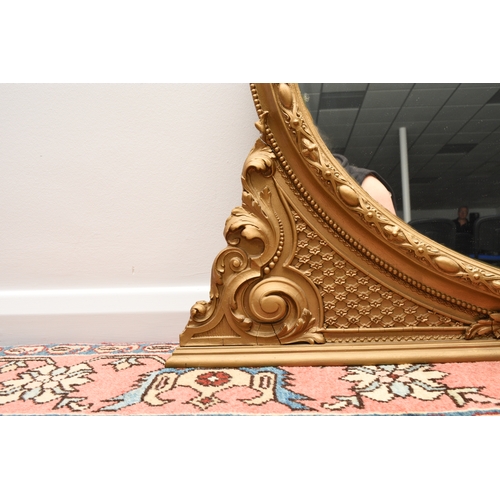 213 - A Victorian giltwood overmantel mirror The oval plate within a moulded frame with shell cresting. 13... 