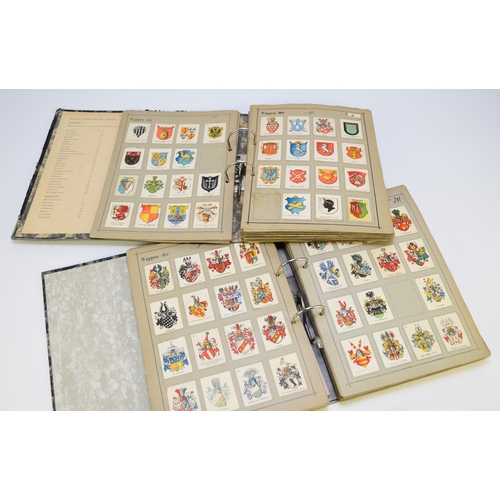 143 - Two albums containing 1890-1910 period poster stamps showing crests on white card (Wappen vershnetto... 