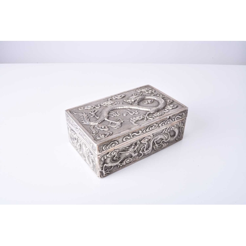 103 - A Chinese silver box, Wang Hing Of rectangular outline with hinged cover, embossed and chased with d... 