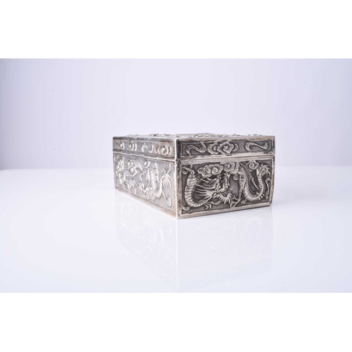 103 - A Chinese silver box, Wang Hing Of rectangular outline with hinged cover, embossed and chased with d... 