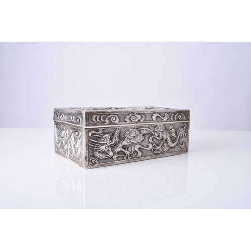 103 - A Chinese silver box, Wang Hing Of rectangular outline with hinged cover, embossed and chased with d... 