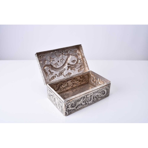 103 - A Chinese silver box, Wang Hing Of rectangular outline with hinged cover, embossed and chased with d... 