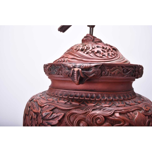 105 - A Chinese cinnabar lacquer censer and cover, Qing Dynasty Of ovoid form raised on four dragon scroll... 