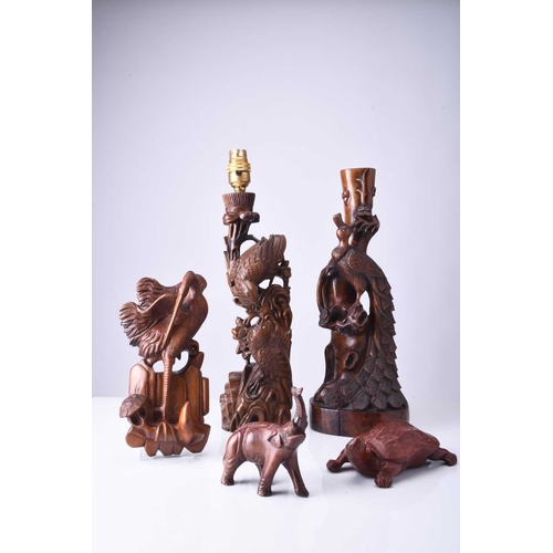 108 - Two Chinese carved hardwood figural lamp bases, Early 20th century The first carved with a peacock p... 