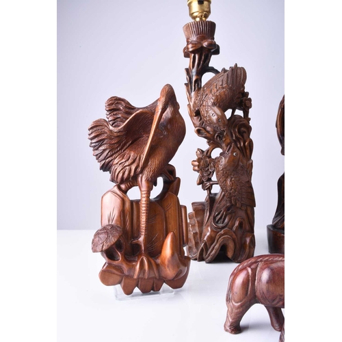 108 - Two Chinese carved hardwood figural lamp bases, Early 20th century The first carved with a peacock p... 