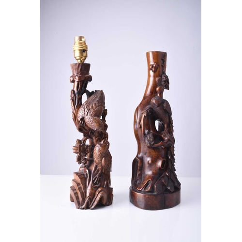 108 - Two Chinese carved hardwood figural lamp bases, Early 20th century The first carved with a peacock p... 