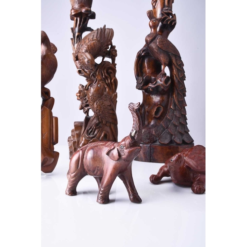 108 - Two Chinese carved hardwood figural lamp bases, Early 20th century The first carved with a peacock p... 