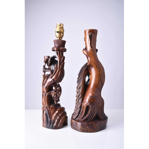 108 - Two Chinese carved hardwood figural lamp bases, Early 20th century The first carved with a peacock p... 