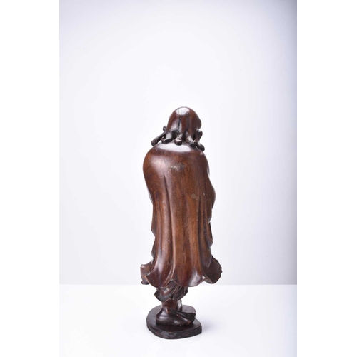 113 - A Chinese carved wood figure of Luohan, Qing Dynasty Modelled standing and holding a scroll. 31cm hi... 