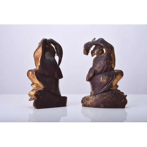 115 - A pair of Chinese gilt wood figures of the twins Hehe Erxian, Qing Dynasty Modelled standing on clou... 