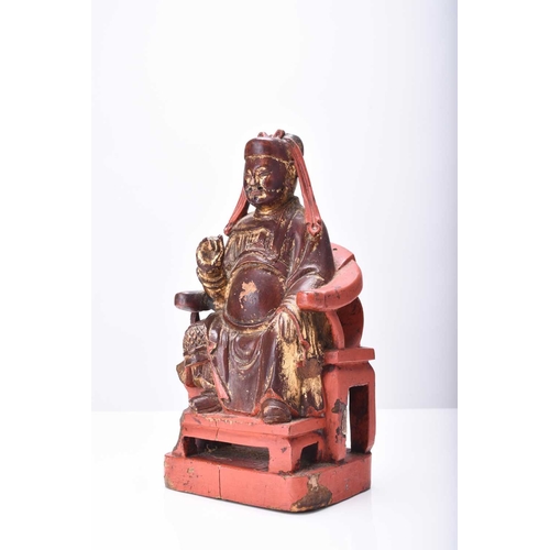 116 - A Chinese painted and parcel gilt wood figure of a seated official, Qing Dynasty 21cm high