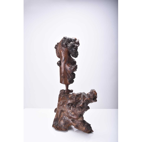 118 - A Chinese carved root wood figure of Luohan, Qing Dynasty Modelled standing on a large knotty root. ... 