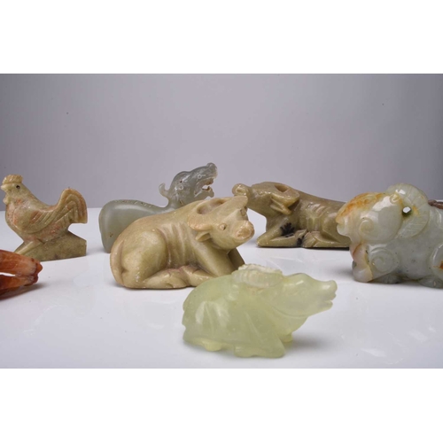 125 - Group of nine Chinese carved hardstone animal figures Including in jade: a ram; a boy on buffalo; a ... 