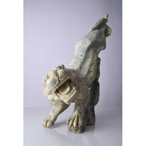 129 - A Chinese carved quartzite figure of a stalking tiger, 20th century Of mottled green hue, stylistica... 