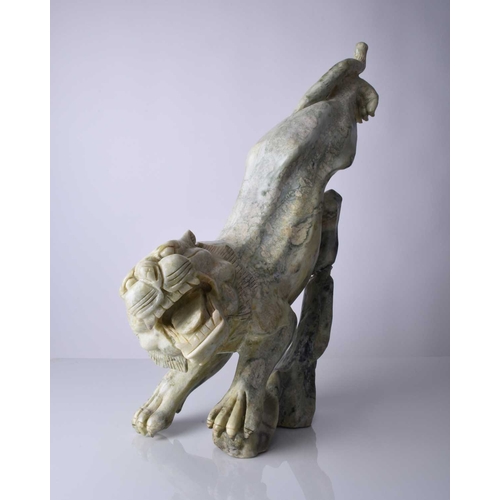 129 - A Chinese carved quartzite figure of a stalking tiger, 20th century Of mottled green hue, stylistica... 