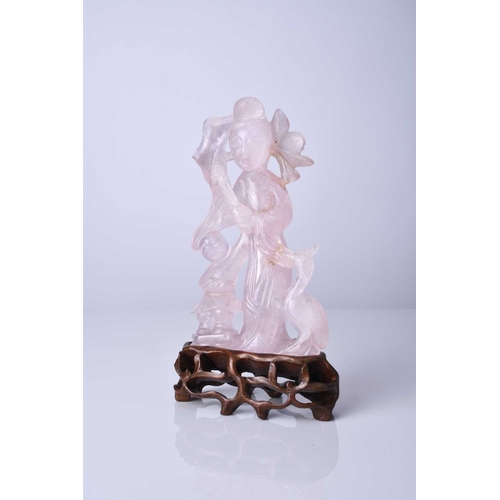 132 - A Chinese rose quartz figure of Guanyin, Qing Dynasty, 19th century With carved hardwood stand. 13cm... 