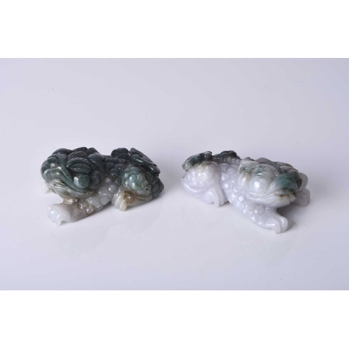 134 - A pair of Chinese jadeite figures of lion dogs, 20th century Of grey and dark green hue. 6.5cm (2)