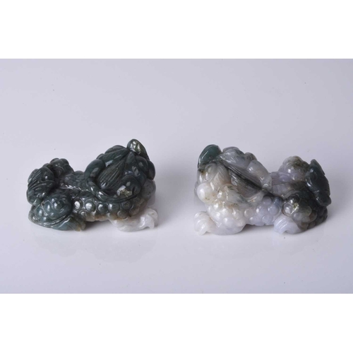 134 - A pair of Chinese jadeite figures of lion dogs, 20th century Of grey and dark green hue. 6.5cm (2)