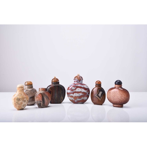 142 - A group of seven Chinese hardstone snuff bottles, 19th/20th century All of flattened ovoid form and ... 