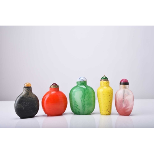 148 - A group of five Chinese glass snuff bottles, 19th/20th century Four of flattened ovoid form and colo... 