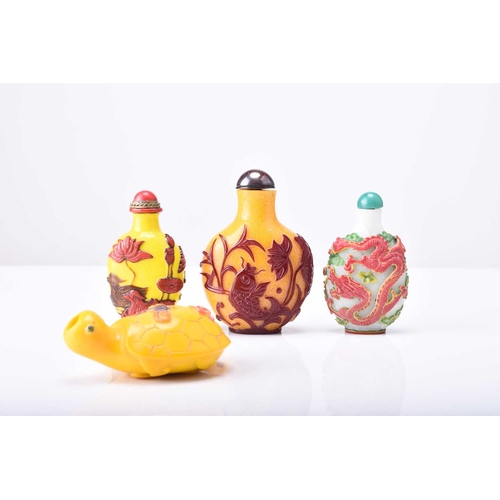 157 - A group of four Chinese overlay glass snuff bottles, 19th/20th century The first yellow overlayed in... 