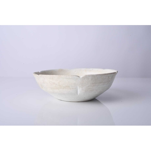 16 - A Chinese ding ware lotus bowl, Song Dynasty Of rounded form with lobed rim, covered in a creamy whi... 