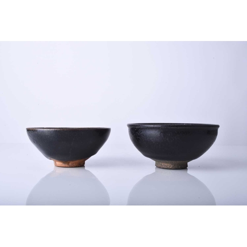 18 - Two Chinese Jian ware bowls, Song Dynasty Of conical form, each decorated with a rich near-black gla... 