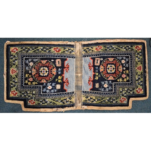 193 - A Tibetan two-piece saddle rug, Qing Dynasty Worked with auspicious flowers and foliage on a dark bl... 