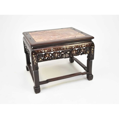 208 - A Chinese inlaid rosewood table or seat, Qing Dynasty, 19th century The moulded top inset with pink-... 