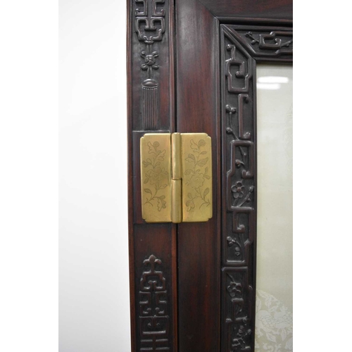 209 - A Chinese Hongmu cabinet, late 19th century The moulded top above a single door with glazed panel in... 