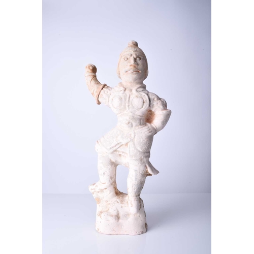 23 - A Chinese buff pottery figure of a guardian Possibly Tang Dynasty Modelled wearing armour and standi... 