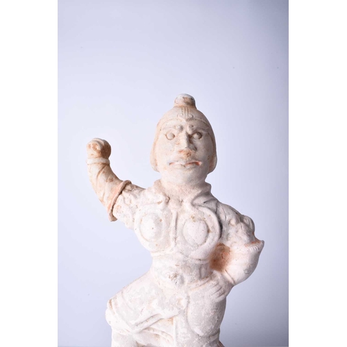 23 - A Chinese buff pottery figure of a guardian Possibly Tang Dynasty Modelled wearing armour and standi... 