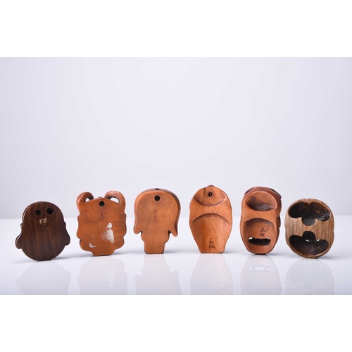 233 - A group of six Japanese wood netsuke of masks, 20th century Four of oni and two of laughing Buddhas,... 