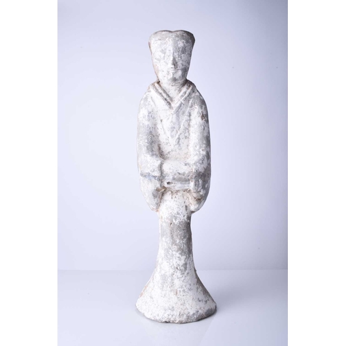 24 - A Chinese grey pottery figure of a maiden, Sui/Tang Dynasty Modelled standing in long robes, her han... 