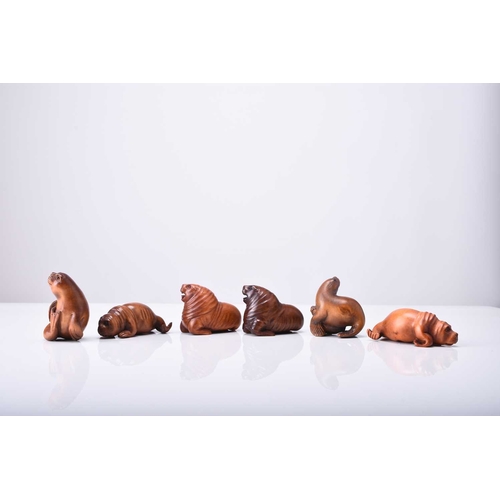 247 - A group of six Japanese wood netsuke of seals and sea lions, 20th century Naturalistically modelled ... 