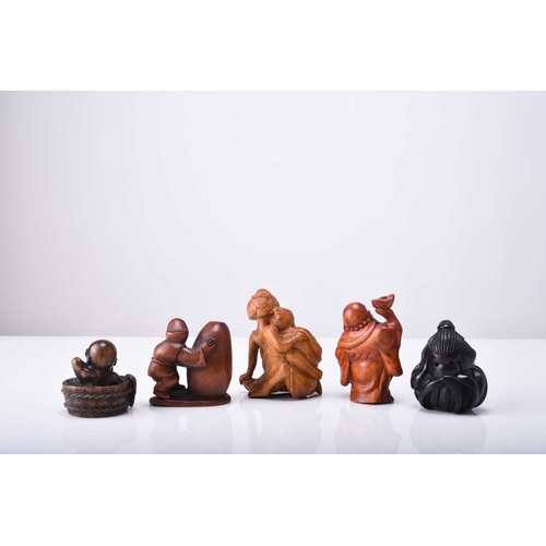 254 - A group of five Japanese wood netsuke, 20th century Including: Shoki trapping an oni; Hotei; a schol... 