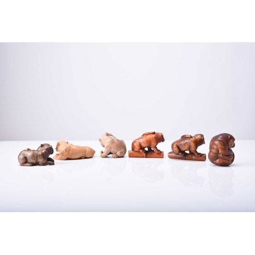 262 - A group of six Japanese wood netsuke of tigers, 20th century Naturalistically and stylistically mode... 