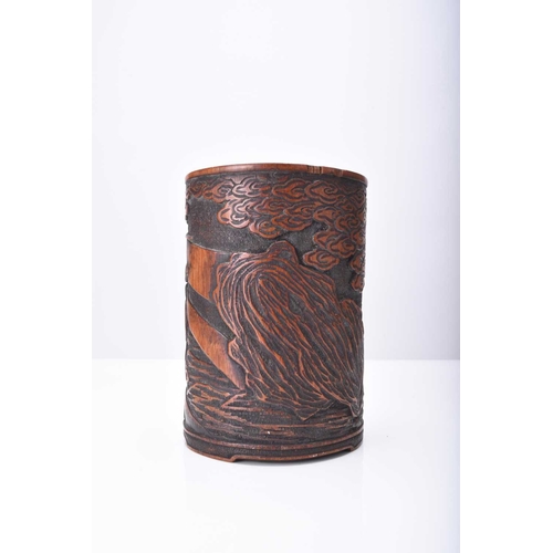 268 - A Japanese carved bamboo brush pot, Meiji era Decorated with a scene of a warrior on horseback in a ... 