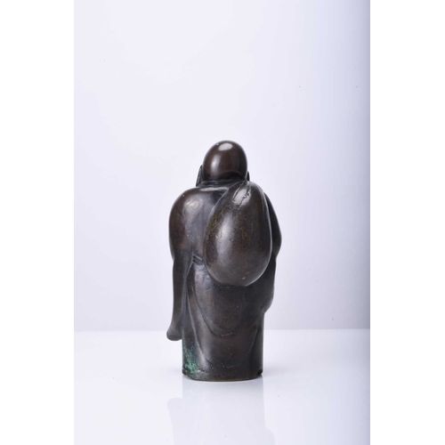 272 - A Japanese bronze figure of Hotei, Meiji era Modelled standing, his robes open at the front, he carr... 