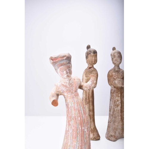 28 - Four Chinese pottery figures of maidens, Tang Dynasty Modelled wearing long robes and differing in p... 