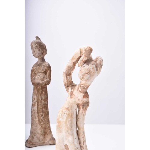 28 - Four Chinese pottery figures of maidens, Tang Dynasty Modelled wearing long robes and differing in p... 