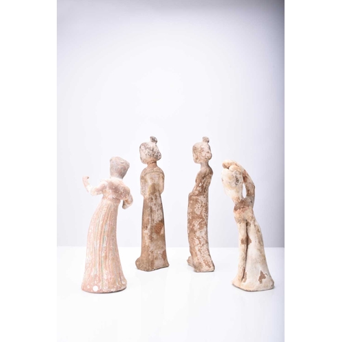 28 - Four Chinese pottery figures of maidens, Tang Dynasty Modelled wearing long robes and differing in p... 